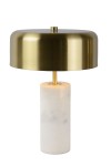 Lampa stołowa Mirasol 3-punktowa, z metalowym, złotym kloszem i białym, cylindrycznym podstawą z marmuru. Ujęcie frontalne, stojąca na jednolitym tle. Widoczny detal włącznika w centralnej części podstawy.