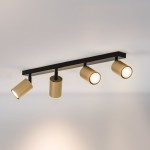 Czarna lampa sufitowa (spot) z czterema złotymi reflektorami, zamontowana na prostokątnej podstawie. Reflektory mają cylindryczny kształt, a ich jasne światło skierowane jest w dół, tworząc nowoczesny akcent oświetleniowy.