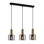 Lampa wisząca Santia 3-punktowa, z trzema szklanymi kloszami w dymionym kolorze i mosiężnymi detalami, zawieszona na czarnym stelażu. Klosze mają cylindryczny kształt, a ich dymione szkło tworzy efektowne oświetlenie.