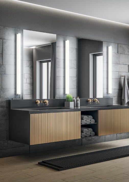 Kinkiet Fabio LED IP44 w kolorze chromu, o długości 120 cm i mocy 20W, zamontowany obok lustra w nowoczesnej łazience. Oświetlenie ma prostą, pionową formę, idealne do aranżacji wnętrz.