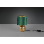 Zielona lampa stołowa Sophia z welurowym kloszem, ozdobna podstawka w złotym kolorze z teksturą. Produkt ustawiony na szarej powierzchni, z widocznym przewodem i przełącznikiem.
