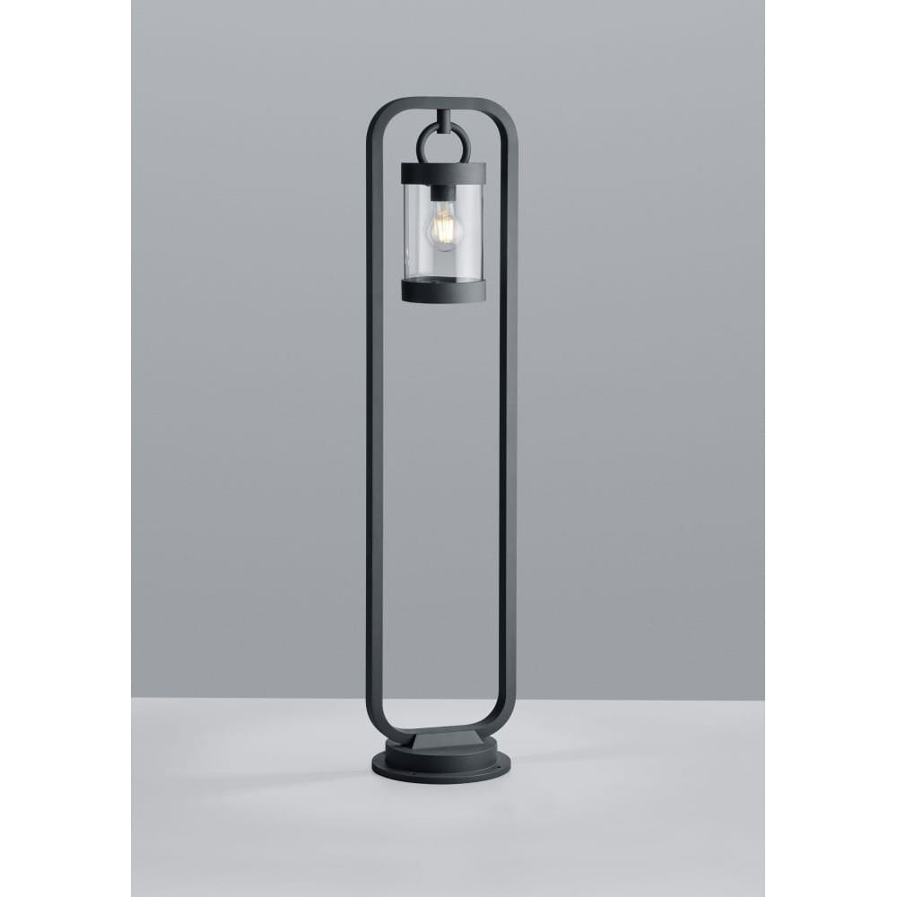 Lampa ogrodowa stojąca Sambesi H100 w kolorze antracytowym z czujnikiem zmierzchu. Prosta, metalowa konstrukcja z okrągłą podstawą i przezroczystym kloszem, zawieszonym na smukłym stelażu. Ujęcie frontalne na jednolitym tle.