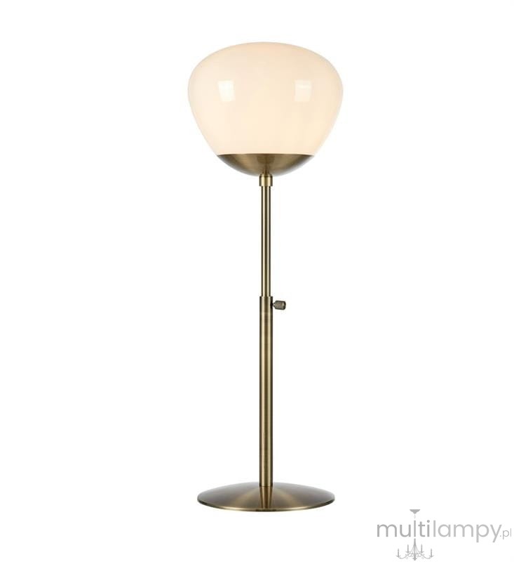 Lampa stołowa Rise 1-punktowa w antycznym mosiądzu z białym kloszem. Stojąca, z metalową podstawą i regulowanym ramieniem. Klosz o zaokrąglonym kształcie, lekko przezroczysty, umieszczony na wysmukłej nodze.