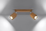 Lampa sufitowa Keke 2-punktowa z drewnianym, prostokątnym mocowaniem i dwoma regulowanymi reflektorami w kształcie heksagonu. Reflektory mają jasne źródło światła, montaż sufitowy, w kolorze naturalnego drewna. Tło neutralne, szare.