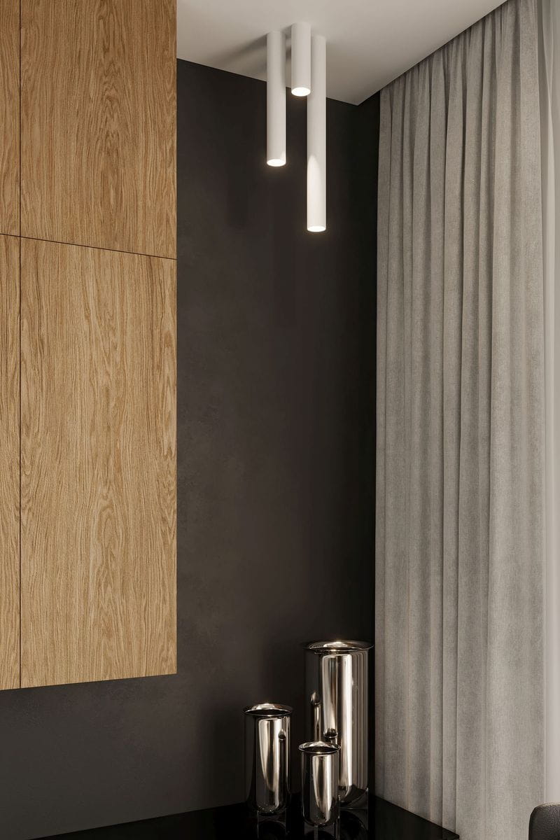 Lagos H30 lampa sufitowa 1-punktowa w białym kolorze, wisząca, z trzema cylindrycznymi źródłami światła. Tło stanowi ciemna ściana z drewnianą zabudową i zasłonami, obok widoczne metalowe pojemniki.