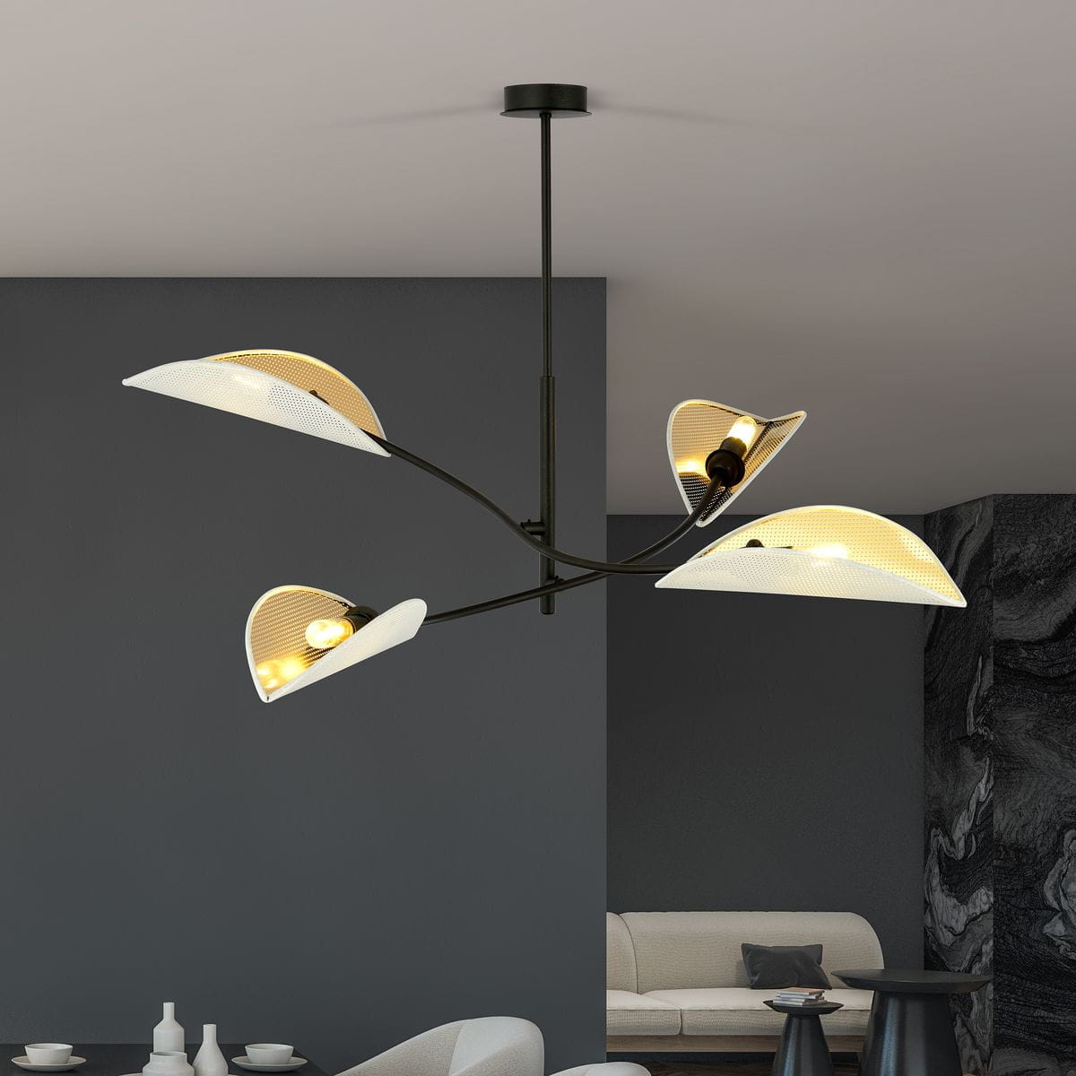 Lampa sufitowa Lotus, 4-punktowa, w kolorze białym i złotym. Ma cztery klosze w kształcie liści z białymi krawędziami, zamontowane na czarnym stelażu. Ujęcie z dołu, lampa wisząca w nowoczesnym wnętrzu.