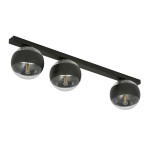 Lampa sufitowa 3-punktowa w kolorze czarnym z metalowym stelażem. Trzy okrągłe klosze w przezroczystym, szklanym wykończeniu z widocznymi żarówkami. Produkt zamontowany na poziomej listwie, w ujęciu frontalnym na jasnym tle.