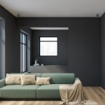 Czarna, okrągła oprawa do zabudowy Bali Round 1-punktowa, umieszczona w suficie, w minimalistycznym wnętrzu z zieloną sofą i dużymi oknami. W tle widoczna szara ściana i nisza z dekoracjami.