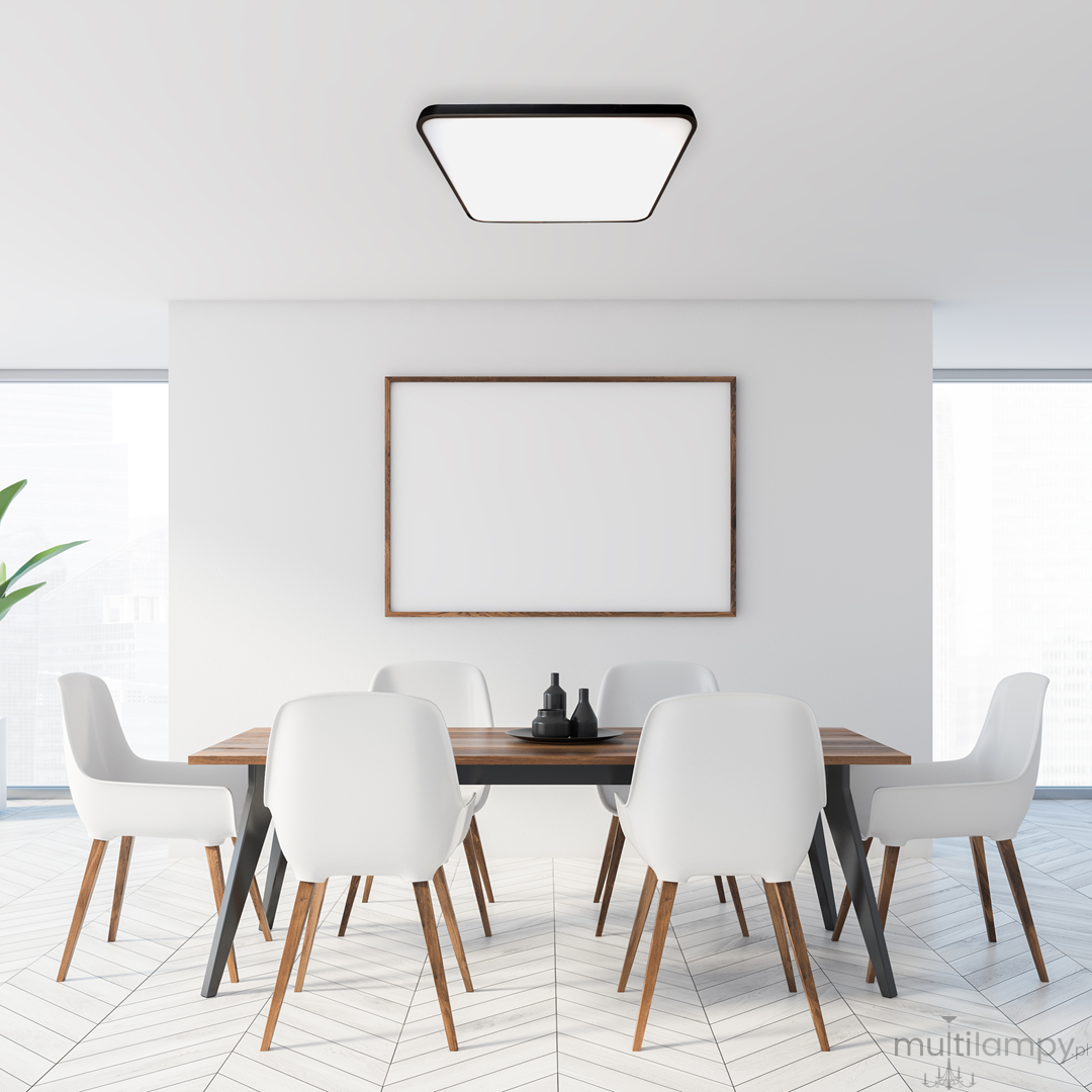 Plafon Fabio LED 35W w kolorze czarnym, o kwadratowym kształcie, zamontowany na suficie w nowoczesnym wnętrzu. Produkt o minimalistycznym designie, oświetlający stół z białymi krzesłami w jasnym pomieszczeniu.