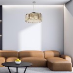 Lampa wisząca Clarissa 5-punktowa w kolorze chromu, okrągła, z wiszącymi elementami dekoracyjnymi. Zawieszona na cienkim przewodzie w nowoczesnym wnętrzu z brązową sofą i czarnym stołem, tworzy elegancki akcent.