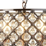 Lampa wisząca Marquise 3-punktowa w antycznej miedzi, z dekoracyjnymi kryształowymi zwisami w kształcie kropli. Ujęcie z bliska, ukazujące metalową strukturę i źródła światła, tworzące elegancką atmosferę.