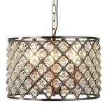 Lampa wisząca Marquise 3-punktowa w antycznej miedzi z przezroczystymi kryształkami w kształcie kropli, zamocowana na metalowej konstrukcji. Ujęcie z boku, ukazujące detale oraz źródła światła wewnątrz klosza.