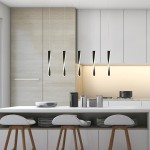 Czarna lampa wisząca Paddle LED 5-punktowa z cienkimi, wydłużonymi kloszami, zawieszona nad białym blatem kuchennym. W tle widać nowoczesne meble kuchenne w odcieniach szarości i drewniane krzesła.