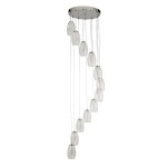 Lampa wisząca Cyclone LED 12-punktowa w chromie, z przezroczystymi kloszami w kształcie owalnym, zawieszona na cienkich linkach. Ułożona w kaskadzie, montowana na okrągłej podstawie sufitowej. Idealna do nowoczesnych wnętrz.