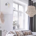 Kinkiet Cyclone LED 1-punktowy w kolorze chromu, z przezroczystym kloszem o cylindrycznym kształcie. Zamontowany na ścianie obok okna, w otoczeniu roślin doniczkowych i nowoczesnych mebli. Wyłącznik na przewodzie.