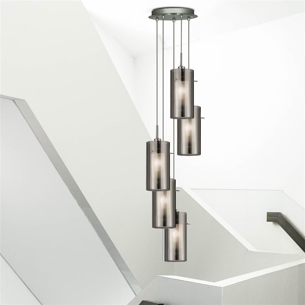Lampa wisząca Duo 2, 5-punktowa, w srebrnej satynie z przydymionymi kloszami. Ułożona w pionie, zawieszona na cienkich linkach. Prosta konstrukcja, nowoczesny design, idealna do wnętrz. Tło jasne, minimalistyczne.