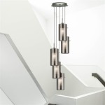 Lampa wisząca Duo 2, 5-punktowa, w srebrnej satynie z przydymionymi kloszami. Ułożona w pionie, zawieszona na cienkich linkach. Prosta konstrukcja, nowoczesny design, idealna do wnętrz. Tło jasne, minimalistyczne.