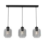 Lampa wisząca Sombra 3-punktowa w kolorze czarnym z dymionymi kloszami. Posiada trzy szklane klosze w kształcie cylindrów, zawieszone na czarnych linkach. Mocowanie na sufit w formie prostokątnej listwy.
