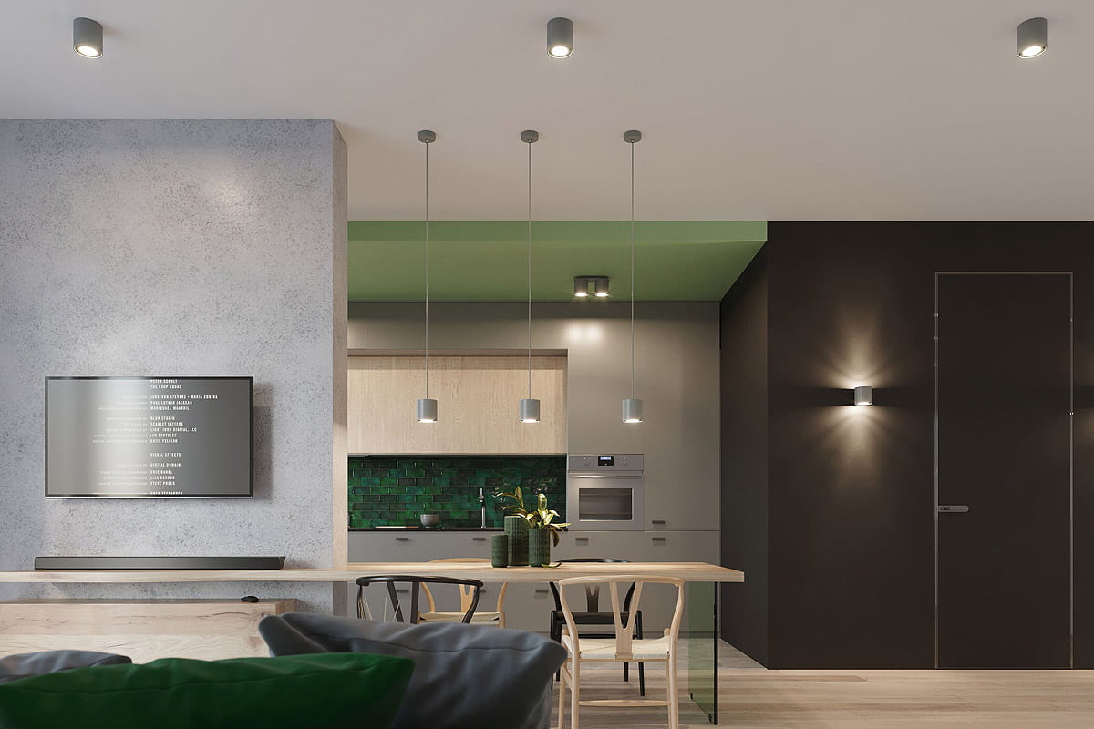 Szara lampa sufitowa Orbis 1-punktowa SL.0018, zamontowana na suficie, w minimalistycznym wnętrzu kuchennym. Lampa ma cylindryczny kształt i metaliczną powierzchnię, oświetlając przestrzeń nad stołem. W tle widoczna zabudowa kuchni i telewizor.