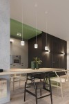 Lampa sufitowa Orbis 2-punktowa w białym kolorze, zawieszona na cienkich linkach. Prezentuje minimalistyczny design z cylindrycznymi kloszami. W tle widać nowoczesne wnętrze z drewnianym stołem i rośliną w zielonych donicach.