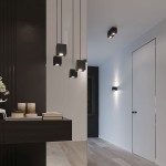 Czarna lampa wisząca 1-punktowa Quad SL.0060 o prostokątnym kształcie, zawieszona na cienkim kablu, umieszczona w eleganckim wnętrzu. Lampa emituje światło w kierunku do dołu, w towarzystwie innych lamp w tym samym stylu.