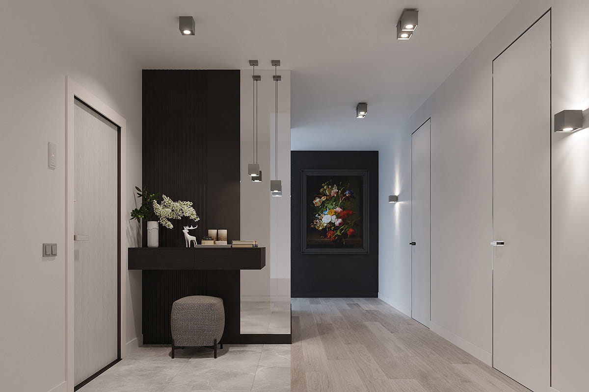 Szara lampa sufitowa 2-punktowa o prostokątnym kształcie, zamontowana na białym suficie. W tle widoczny nowoczesny przedpokój z czarnym akcentem ściennym, drewnianą podłogą oraz dekoracjami na stole. Oświetlenie skierowane w dół.