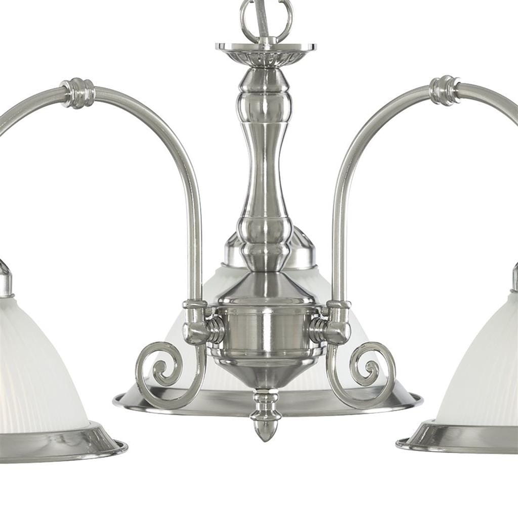 Lampa wisząca American Diner, 3-punktowa, w kolorze satynowego srebra. Posiada elegancką, metalową konstrukcję oraz trzy klosze z białego, teksturowanego szkła. Ujęcie frontalne, z widocznymi dekoracyjnymi detalami na ramionach oraz centralnym elemencie.