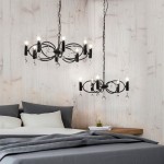 Lampa wisząca Infinity 8-punktowa w kolorze czarnym, z eleganckimi, przezroczystymi kryształkami i oświetleniem w kształcie świec. Zawieszona na długich łańcuszkach, idealna do nowoczesnych wnętrz, w tle widoczna sypialnia z szarymi tekstyliami.