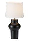 Lampa stołowa Shape w kolorze czarnym z białym abażurem. Okrągła podstawa z matowego metalu, zwężająca się ku dołowi. Abażur w kształcie cylindrycznym, lekko zaokrąglony u góry. Złoty detal przy mocowaniu abażuru. Ujęcie frontalne, stojąca.
