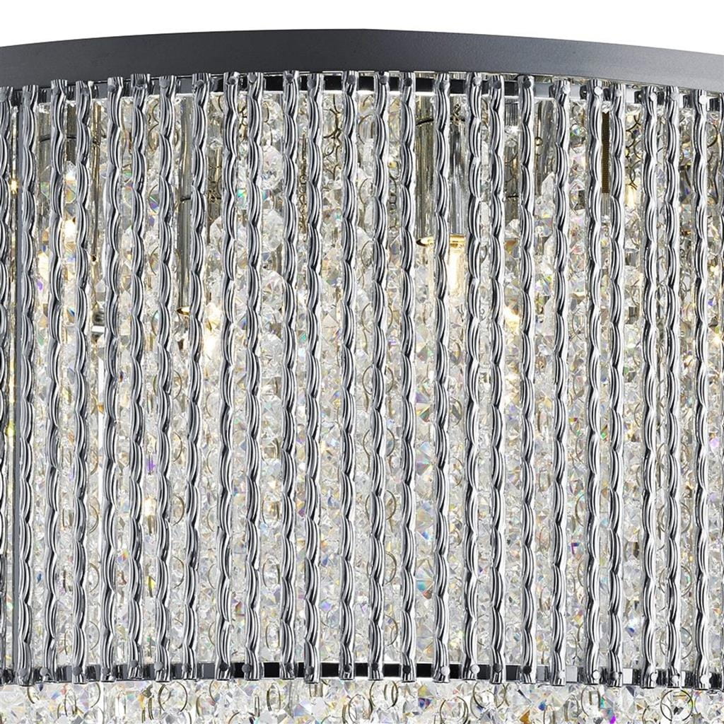 Lampa wisząca Elise I, 8-punktowa, w chromowanej obudowie. Posiada przezroczyste kryształowe elementy w formie wiszących łańcuchów, które tworzą efektowną, błyszczącą teksturę. Ujęcie z góry, ukazujące detal i stylowy design.