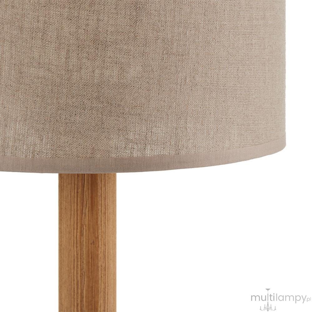 Lampka stołowa Deva Nature 1-punktowa, z okrągłym kloszem w jasnym, teksturowanym materiale, na drewnianej nodze o naturalnym wykończeniu. Widok z boku na detale klosza i podstawy. Idealna do minimalistycznych aranżacji.
