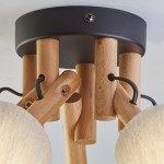 Lampa sufitowa Vaio 5-punktowa w kolorze czarnym z drewnianymi elementami. Widok z góry, prezentujący mocowanie oraz klosze w formie okrągłych, teksturowanych osłon. Metalowa podstawa w kolorze czarnym, drewniane ramiona w naturalnym odcieniu.