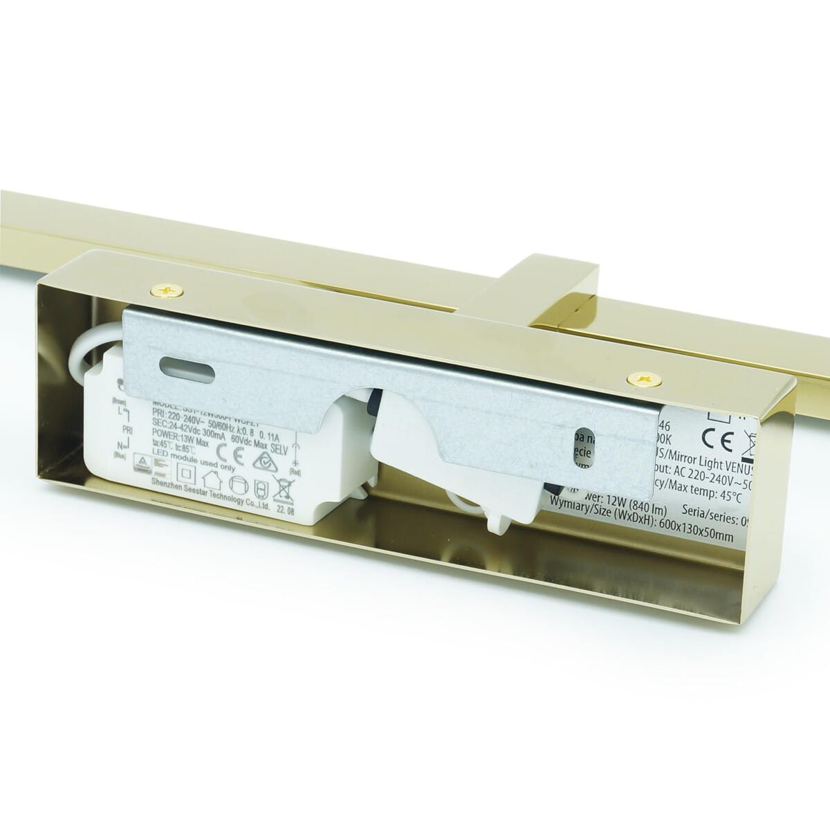 Złoty kinkiet łazienkowy Venus LED IP44, o wymiarach 600x130x50 mm, z widocznym zasilaczem i kablami, zamontowany w prostokątnej obudowie. Ujęcie z boku, z detalem na tylnej stronie.
