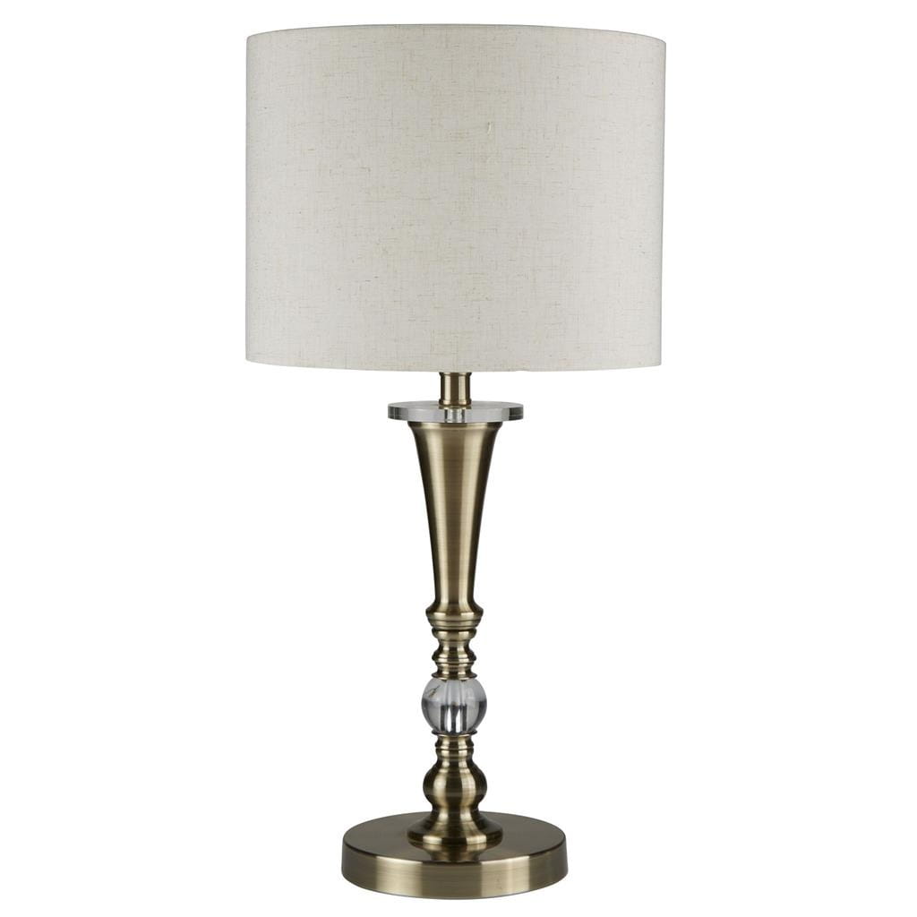 Lampa stołowa Oscar 1-punktowa w antycznym mosiądzu. Posiada smukłą podstawę z teksturowanego metalu i szklany detal w kształcie kuli, zakończona białym kloszem z tkaniny w kształcie walca. Ustawiona na okrągłej podstawie.