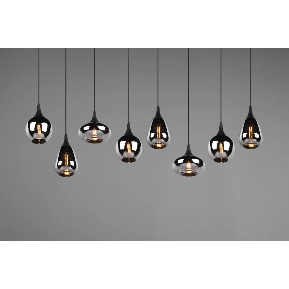 Osiem punktów świetlnych w lampie wiszącej Lumina, w kolorze czarnym i chromowanym. Lampa w kształcie kropli, zawieszona na cienkich linkach, z widocznymi żarówkami w środku, na szarym tle.
