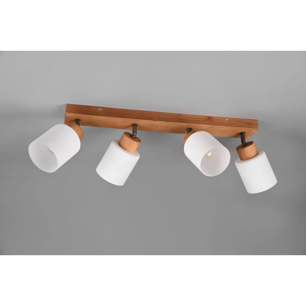 Czteropunktowa lampa sufitowa Assam z drewna, z białymi kloszami. Klosze mają okrągły kształt i są zamocowane na drewnianej listwie. Lampa montowana jest na suficie, w kolorze naturalnego drewna.