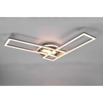 Lampa sufitowa Twister LED w kolorze niklowym z pilotem. Posiada nowoczesny design z dwiema prostokątnymi ramkami, ułożonymi w krzyż, emitującymi ciepłe światło. Zamontowana na okrągłej podstawie, z widocznymi detalami wykończenia.