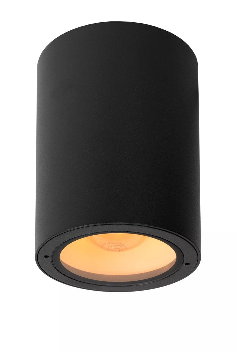 Lampa sufitowa elewacyjna Volantis w kolorze czarnym, cylindryczny kształt, zamontowana w pozycji wiszącej. Wewnątrz widoczna ciepła, złota żarówka. Powierzchnia matowa, prosta konstrukcja, idealna do nowoczesnych wnętrz.