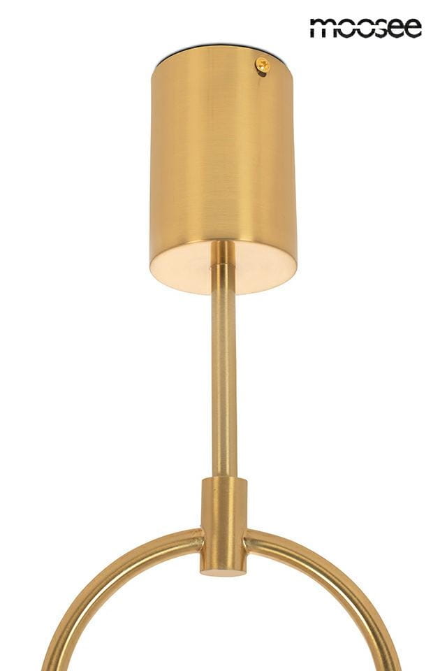 Lampa wisząca 2-punktowa w kolorze złotym, z cylindrycznym kloszem i prostym uchwytem. Ujęcie z dołu, ukazujące elementy montażowe i gładką powierzchnię metalu. Brak widocznych napisów lub logo.