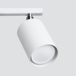 Biała lampa sufitowa Lemmi z trzema punktami świetlnymi, wykonana z matowego materiału. Ujęcie z boku, pokazujące cylindryczny kształt oprawy i jasne, okrągłe źródło światła. Prosta konstrukcja montowana na ścianie.