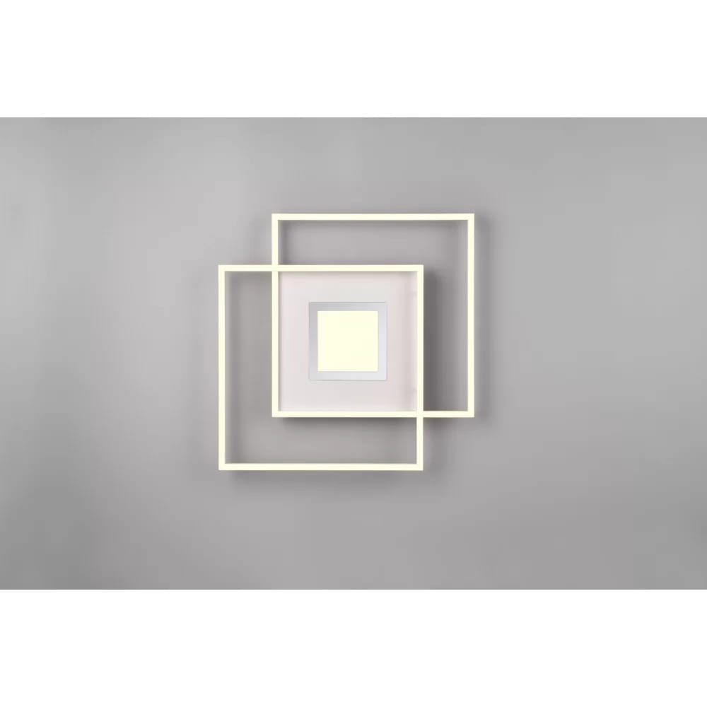 Biała lampa sufitowa LED 3-punktowa Via, z pilotem, w kształcie nakładających się kwadratów. Główna część z matowym szkłem, otoczona ramkami w kolorze białym. Ujęcie frontalne na szarym tle, podkreślające nowoczesny design.