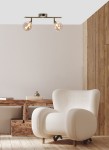 Lampa sufitowa Rodia 2-punktowa w kolorze patyny z bursztynowymi kloszami. Produkt montowany na suficie, z widocznymi żarówkami, zawieszony na metalowej konstrukcji z dwiema ramionami. Tło w jasnych odcieniach, w aranżacji z nowoczesnym fotelem.