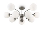 Lampa sufitowa Erich 10-punktowa w kolorze niklowym, z białymi, okrągłymi kloszami. Posiada 10 punktów świetlnych umieszczonych na metalowych ramionach, rozłożonych w promienisty sposób. Produkt zamontowany na okrągłej podstawie.