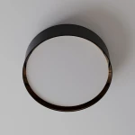 Plafon Bilbao D60 w czarnym kolorze, okrągły, o gładkiej, matowej powierzchni. Zawiera cztery punkty świetlne, montowany na suficie, widoczny z góry. Delikatne wykończenie w odcieniu złota wewnątrz obrzeża.