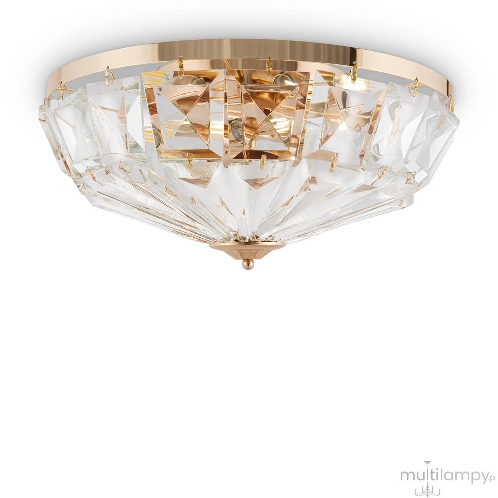 Lampa sufitowa 6-punktowa w kolorze złotym z przezroczystymi, szklanymi elementami w kształcie piramid. Ujęcie z dołu, prezentująca elegancki design i efektowne odbicie światła. Montowana pod sufitem, idealna do nowoczesnych wnętrz.