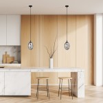 Lampa wisząca Astral 1-punktowa w kolorze czarnym i grafitowym, z okrągłym kloszem, zawieszona na cienkim przewodzie. Ujęcie z góry, w nowoczesnej kuchni z drewnianymi akcentami, obok biały wazon z gałęzią na marmurowym blacie.