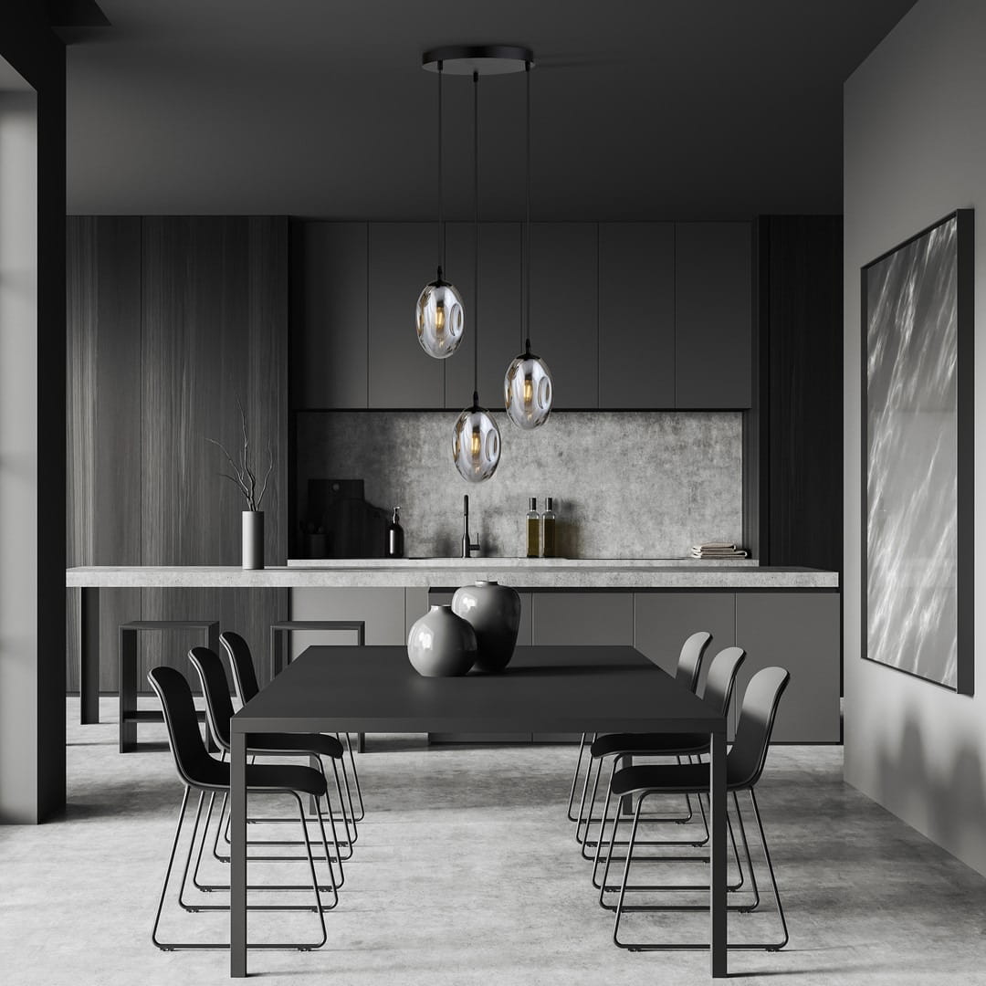 Lampa wisząca Astral 3-punktowa w kolorze czarnym i grafitowym, zawieszona nad stołem w nowoczesnej kuchni. Szklane klosze w kształcie kul, metalowe mocowanie, minimalistyczny styl. Otoczenie w odcieniach szarości i czerni.