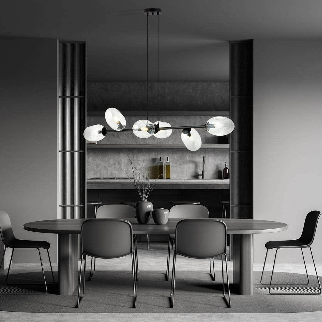 Lampa wisząca Pandora 6-punktowa w kolorze czarnym i transparentnym, z sześcioma szklanymi kloszami w kształcie owalnym, zawieszona nad okrągłym stołem w minimalistycznej aranżacji, na tle szarej ściany i drewnianych półek.
