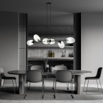Lampa wisząca Pandora 6-punktowa w kolorze czarnym i transparentnym, z sześcioma szklanymi kloszami w kształcie owalnym, zawieszona nad okrągłym stołem w minimalistycznej aranżacji, na tle szarej ściany i drewnianych półek.