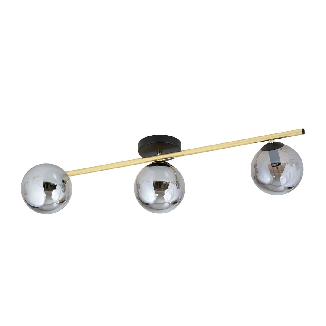 Lampa sufitowa 3-punktowa w kolorze czarnym, złotym i grafitowym. Składa się z trzech kulistych kloszy o lustrzanej powierzchni, zamontowanych na poziomej, złotej rurze. Klosze są zawieszone na czarnym mocowaniu.